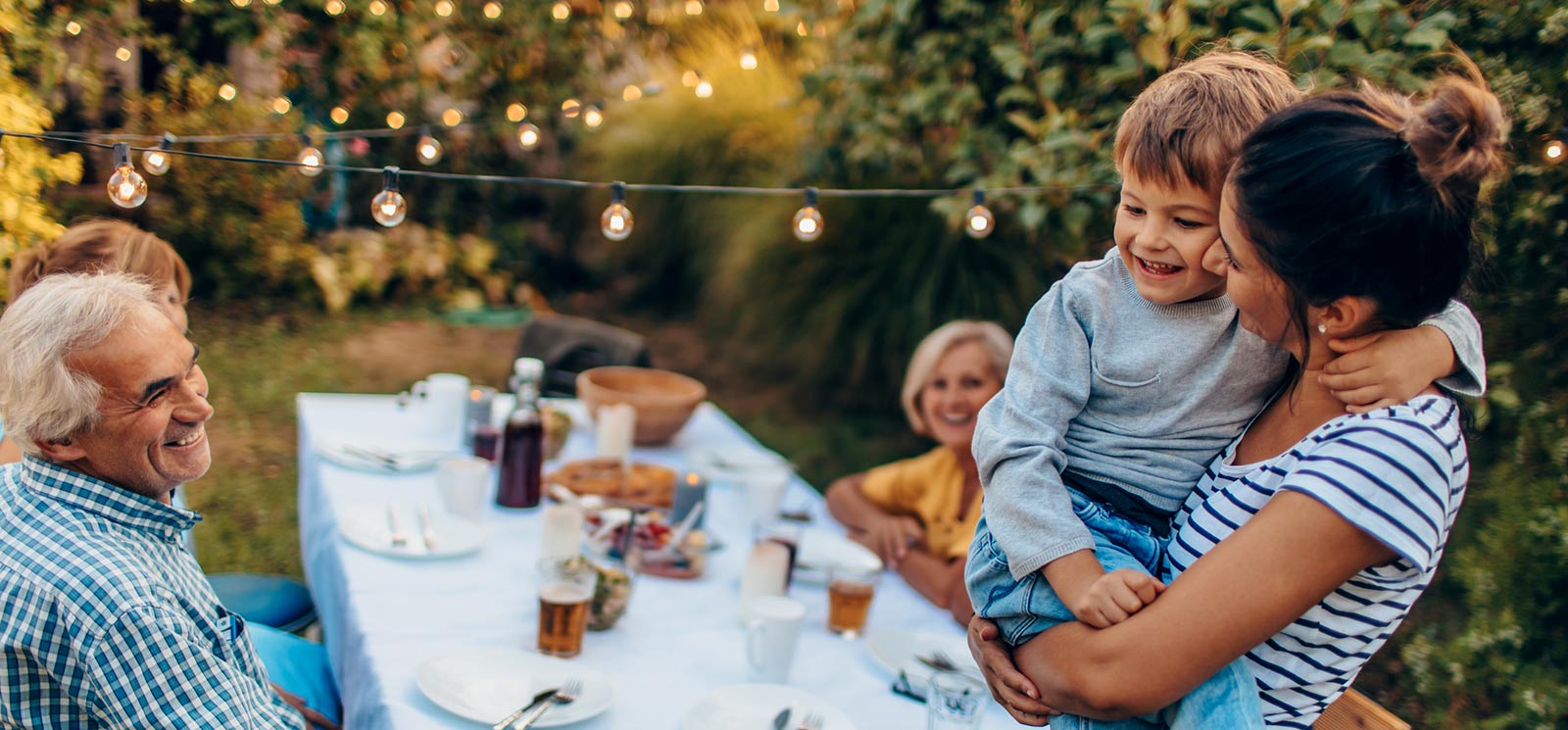 Extended family hanging out in backyard.