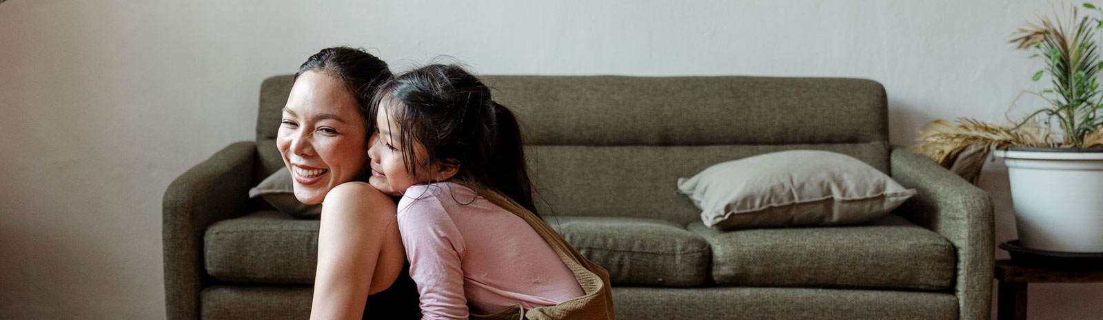 Mom and daughter hanging in living room.