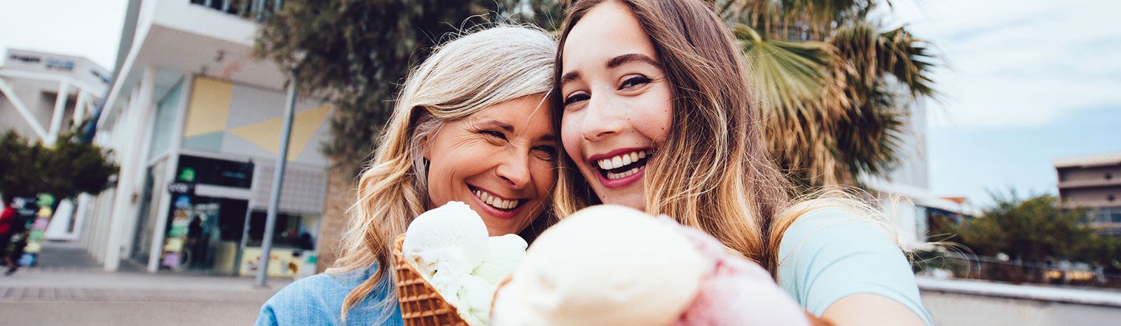 Two ladies taking selfie with ice cream.